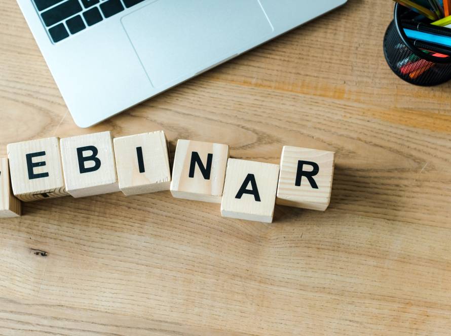 wooden cubes with webinar letters near laptop